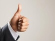 © chayantorn - A confident business person giving a thumbs-up gesture, symbolizing success and positive feedback in the workplace.