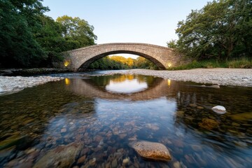 A picturesque stone bridge creates a serene scene as its reflection glimmers on the calm waters below, embodying tranquility and harmony in nature's beauty.