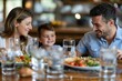 © Aleksandr S - A family sits together at a dining table, sharing a meal filled with colorful dishes and water, emphasizing the importance of healthy eating and bonding moments during mealtime
