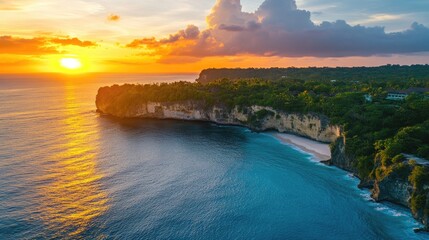Poster - Aerial view of a vibrant sunset illuminating serene island beaches and cliffs with warm orange and blue tones over a tranquil ocean landscape