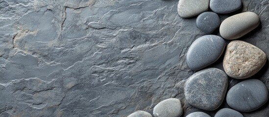 Poster - Grey Basalt Stone Surface with Smooth Pebbles and Empty Copy Space for Text in a Natural Elegant Setting