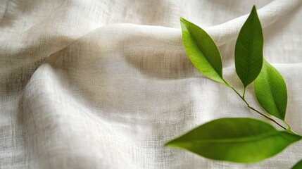 Poster - Natural White Linen Fabric Background with Green Leaves and Selective Focus in Wide Format for Textures and Eco-Friendly Themes