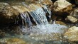 © Giovanni - Tranquil Natural Spring Waterfall Cascading Over Stones in Lush Forest for Travel and Eco-Tourism Exploration