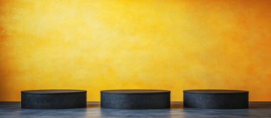 Poster - Black podiums on gray floor against vibrant yellow backdrop with ample copyspace for text and graphic design elements