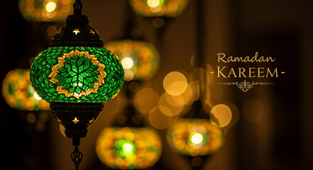 Poster - Decorative Ramadan lantern with green and gold mosaic glass. Ramadan Kareem text with decorative elements on dark background