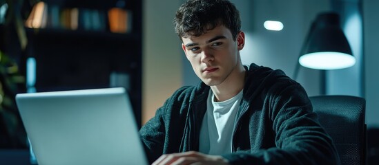 Poster - Young male data analyst concentrating on laptop in modern office setting with ample empty space for creative text or design elements