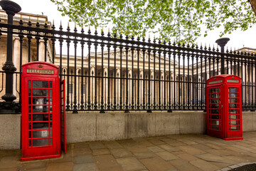 Wall Mural - Red telephone boxes with British museum at background, London, UK