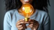 © Exsinghas - A person holding a glowing lightbulb as a symbol of creativity and innovation