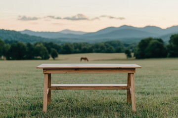Poster - Empty wooden table in a peaceful field at sunrise, perfect for displaying products or enjoying nature