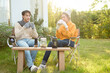 © tonefotografia - Enjoying Warm Drinks and Conversation in a Sunny Outdoor Garden During Autumn Afternoon