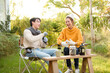 © tonefotografia - Enjoying Warm Drinks and Conversation in a Sunny Outdoor Garden During Autumn Afternoon