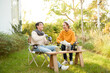 © tonefotografia - Enjoying Warm Drinks and Conversation in a Sunny Outdoor Garden During Autumn Afternoon