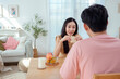 © tonefotografia - Couple Enjoys a Cheerful Breakfast at a Bright, Modern Dining Table in a Cozy Home Setting
