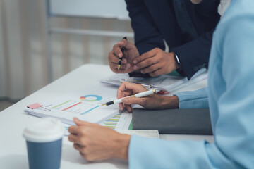 Wall Mural - Collaborative Business Analysis: Close-up shot of businesspeople reviewing financial charts and graphs during a meeting, showcasing teamwork and strategic planning.  