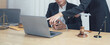 © Kritdanai - Legal Consultation:  Two professionals, one a lawyer and one a client, are engrossed in a serious legal consultation, showcasing the intricate and crucial process of navigating legal matters.