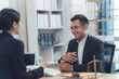 © Kritdanai - Legal Consultation: A professional lawyer, clad in a crisp suit, engages in a productive consultation with a client, reflecting a scene of legal expertise, trust, and problem-solving.