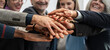 © Lomb - Diverse hands stacked together in teamwork gesture, business collaboration and unity