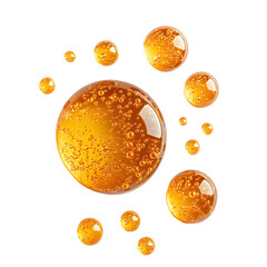 round golden drops of oil or serum on white background, retinol, vitamin c serum droplets