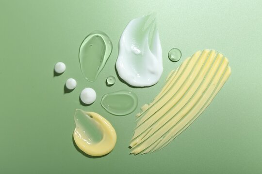 Wall Mural -  - cream and gel samples on green background, top view