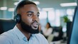 © JK_kyoto - Young Professional Man Wearing Headphones at Modern Office Desk
