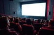 © Krystsina - White cinema screen with people on red chairs in the foreground