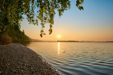Wall Mural - a panoramic view of the morning fog over the river, with the sun shining through.