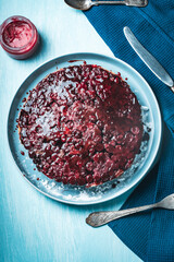 Sticker - Cherry chocolate clafutis on a light blue plate. French pie according to a traditional recipe. A quick homemade dessert. Vertical photo