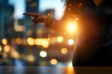 Poster - Silhouette of business person pointing forward against urban bokeh lights background, dramatic sunset lighting creates leadership concept.
