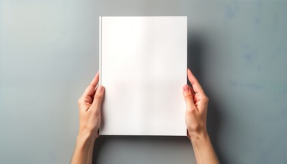 Aufkleber - Female hands hold blank white magazine on gray background. Top view. Mockup design template. Empty page. Suitable for design presentations. Creative ideas. Print, digital media. Versatile layout.