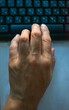 © Serhii - Hand positioned over keyboard during computer work in a quiet setting