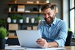 © velikiyzayats - Engaged Young Man Smiling While Working on Laptop in Modern Office with Greenery and Contemporary Décor