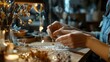 © Wilasini - Close up view of skilled hands of an artisan meticulously crafting a handmade jewelry piece in a cozy rustic creative workspace with warm lighting and wooden table