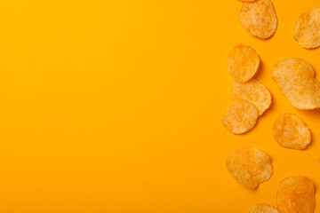 Wall Mural - Crispy potato chips on a yellow background