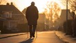 © aliececome - Elderly person using a cane, walking along a quiet street, early morning light illuminating their path, a few houses and trees in the background.