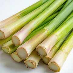 Fresh lemongrass stalks, vibrant green, white isolate background.