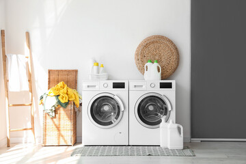 Wall Mural - Interior of laundry room with washing machines and dirty clothes in basket