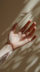Poster - A hand is extended with the palm facing upward, inviting and open. Soft light casts gentle shadows across the surface, creating an intimate and serene atmosphere