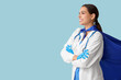 © Pixel-Shot - Beautiful female doctor in superhero costume on blue background
