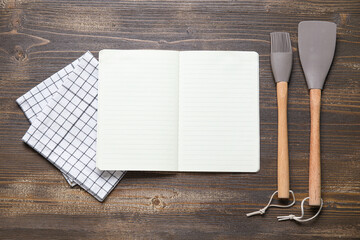 Canvas Print - Blank recipe book, napkin, pastry brush and spatula on wooden background