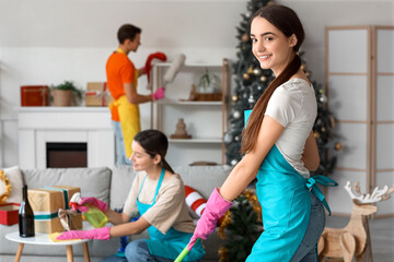 Canvas Print - Female janitor mopping in room after New Year party