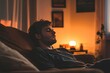 © KerXing - Cozy Evening Relaxation - Young Man Resting on Sofa in Warm Ambient Lighting at Home