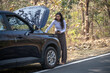 © Ojas - Car with open hood and emergency lights staying on the roadside in forest. hitchhikes to ask for help