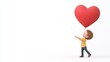 © Ronnakrit - Joyful Boy Gazing at a Large Red Heart Balloon Against White Background