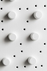 Poster - a textured surface displays a precise arrangement of black dots and raised white circles. the design