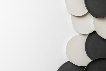 Poster - A composition featuring circular shapes in shades of black and white overlaps on a light background, presenting an abstract yet harmonious visual arrangement of forms and colors