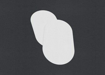 Poster - Two white oval sheets overlapping on a dark background, Blank white Business card mockup stacks at grey textured paper background