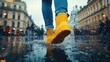 © O - Yellow boots splashing in rain puddle on urban street
