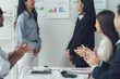 © Kritdanai - Successful Presentation: A diverse team applauds a colleague after a successful presentation, showcasing collaboration, achievement, and positive workplace dynamics.