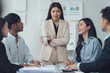 © Kritdanai - Business Meeting Collaboration: A focused and diverse team engages in a productive meeting, led by a confident female professional. The atmosphere is collaborative and professional.