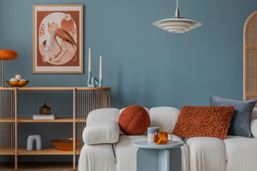 Wall Mural - Contemporary living room with a cream boucle sofa and playful textures in warm and cool tones, framed by elegant wooden shelving.